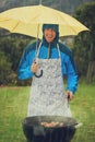 Happy man, portrait and umbrella in rain for barbecue meal, supper or dinner on the fire grill. Male person smiling for