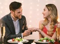 Happy man putting engagement ring on girlfriends hand at romantic dinner Royalty Free Stock Photo