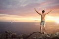 Happy man with raised arms on top of a sea cliff Royalty Free Stock Photo