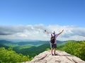 Happy man with raised hands on top of the mountain Royalty Free Stock Photo