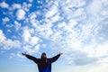 Happy man raised wide open arms traveling hiker blue sky and clouds healthy lifestyle adventure vacations outdoor success joyful Royalty Free Stock Photo