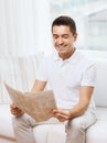 Happy man reading newspaper at home Royalty Free Stock Photo