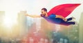 Happy man in red superhero cape flying on air Royalty Free Stock Photo