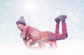 Happy man in a red sweater sledding. Winter, sun, snow, flares. Royalty Free Stock Photo