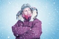 Happy man in red winter clothes warms his hands, cold, snow, frost, blizzard Royalty Free Stock Photo