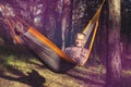 Happy man relaxes, lying in a hammock Royalty Free Stock Photo