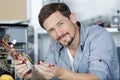 Happy man repairing computer