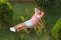 Happy man resting in deck chair, above view