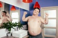 Funny fat man in the shower. Bath Royalty Free Stock Photo