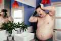 Funny fat man in the shower. Bath Royalty Free Stock Photo