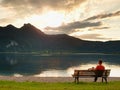 Happy man with rised arms in red t-shirt stand on tree stump Royalty Free Stock Photo