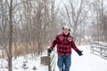 Happy man in plaid playing in the snow