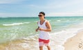 Happy man running along summer beach Royalty Free Stock Photo