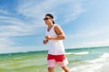 Happy man running along summer beach Royalty Free Stock Photo