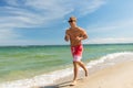 Happy man running along summer beach Royalty Free Stock Photo