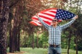 Happy man running with USA flag. Celebrating Independence Day of America. July 4th. Man having fun Royalty Free Stock Photo