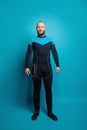 Happy man scuba diver standing on blue background Royalty Free Stock Photo