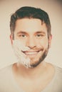 Happy man with shaving cream foam on half of face. Royalty Free Stock Photo