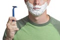 Happy man with shaving foam on his face holding razor. Man is shaving Royalty Free Stock Photo