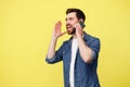 Happy man shouting loudly while talking on the phone and gesturing with his hands Royalty Free Stock Photo