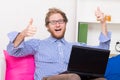 Happy man shows OK sign in front of a computer Royalty Free Stock Photo