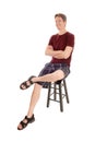 Happy man sitting on a chair smiling Royalty Free Stock Photo