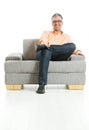 Happy man sitting on couch Royalty Free Stock Photo