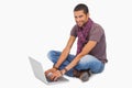 Happy man sitting on floor using laptop Royalty Free Stock Photo