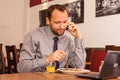 Happy man sitting in restaurant with laptop Royalty Free Stock Photo