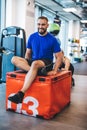 Happy man sitting on weight pushed by a woman.