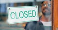 Happy man, small business or closed sign on window in coffee shop or restaurant for end of service. Closing time, smile Royalty Free Stock Photo