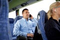 Happy man with smartphone and laptop in travel bus Royalty Free Stock Photo