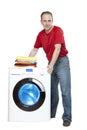 Happy man smiling standing next to a new washing machine Royalty Free Stock Photo