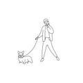 Happy man speaks on phone and walks dog. Pretty guy holds phone and leads dog on leash. Male walking with pet. Young man