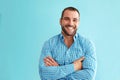 Man standing in front of turquoise wall