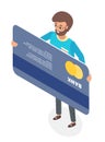 A happy man standing holding his credit card. Micro male character and big plastic bank card Royalty Free Stock Photo