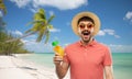 Happy man in straw hat with juice on beach Royalty Free Stock Photo