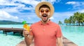 Happy man in straw hat with juice on beach Royalty Free Stock Photo