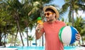 Happy man in straw hat with juice on beach Royalty Free Stock Photo