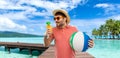 Happy man in straw hat with juice on beach Royalty Free Stock Photo