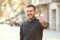 Happy man in the street gesturing thumbs up Royalty Free Stock Photo