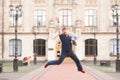 Happy man student with books in his hands jumping against the background of the university building Royalty Free Stock Photo