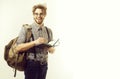 Happy man or student traveler smiling with backpack and notebook