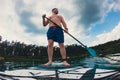 happy man on supboard paddling