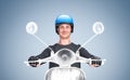 Happy man in a t-shirt and motorcycle helmet rides an imaginary motor scooter, on a blue background. Front view. Royalty Free Stock Photo