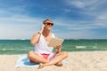 Happy man with tablet pc and headphones on beach Royalty Free Stock Photo