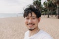 Happy man take selfie with palm tree on the beach. Summer travel concept. Royalty Free Stock Photo