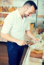 Happy man taking with scoop cereals sold Royalty Free Stock Photo