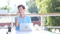 Happy Man Talking on Phone, Sitting at Work, Outdoor Royalty Free Stock Photo