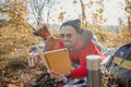 Happy man with tea and notebook in forest stock photo Royalty Free Stock Photo